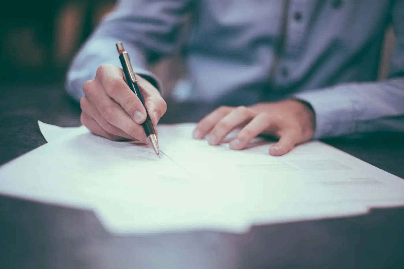 Signing papers. Illustrative photo.