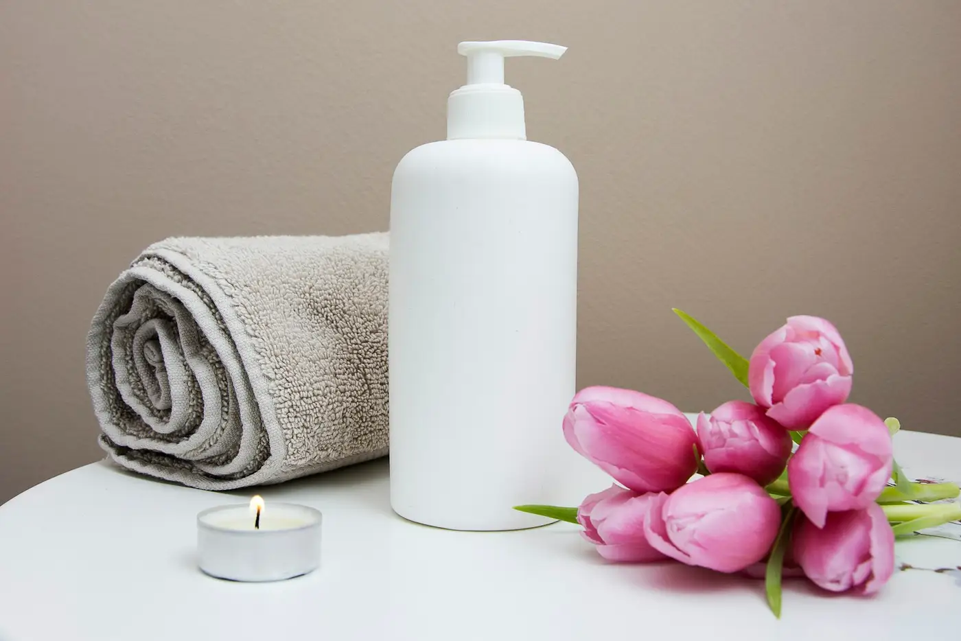 Towel, candle, and flowers. Illustrative spa photo.
