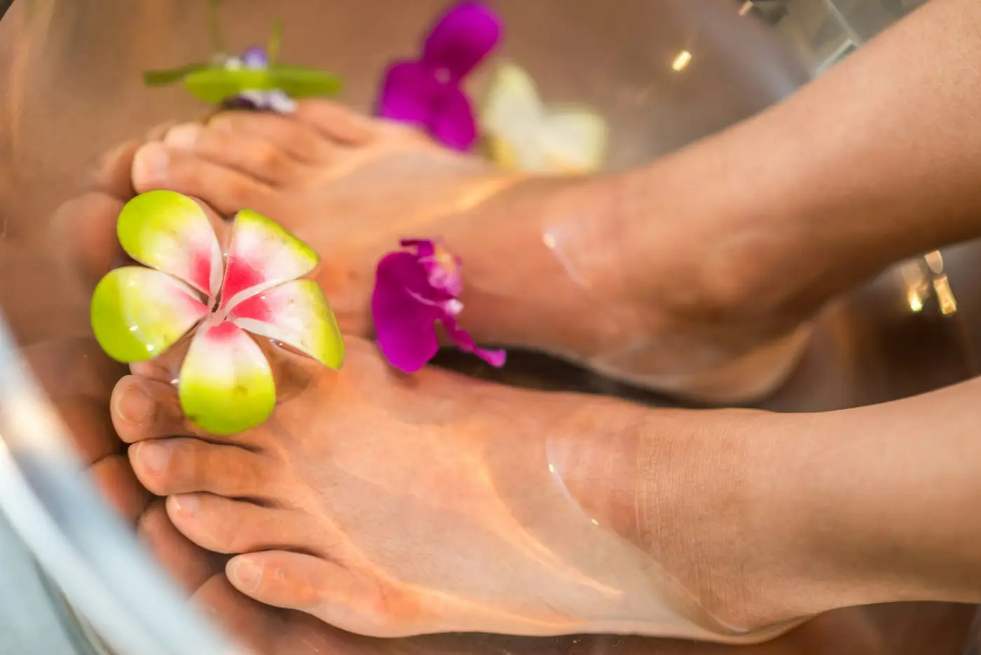 Foot bath with flowers. Illustrative spa photo.