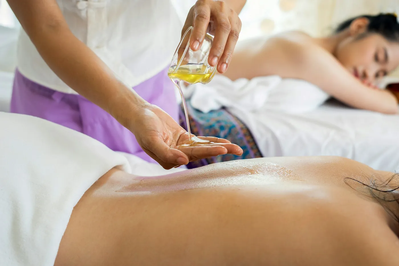 Massage with warm oil. Illustrative spa photo.